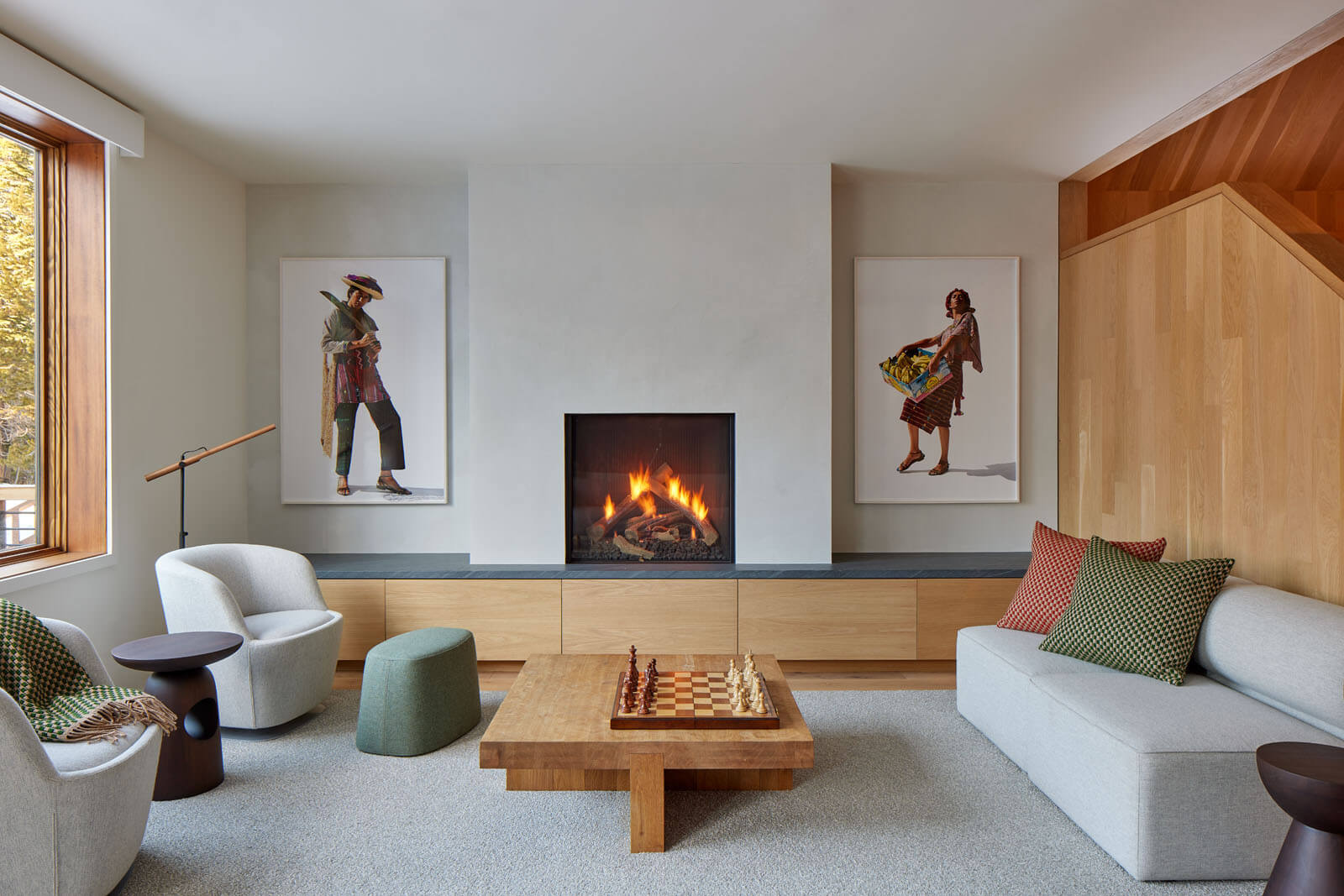 A living room with a white fireplace and artwork on either side at Pennyroyal