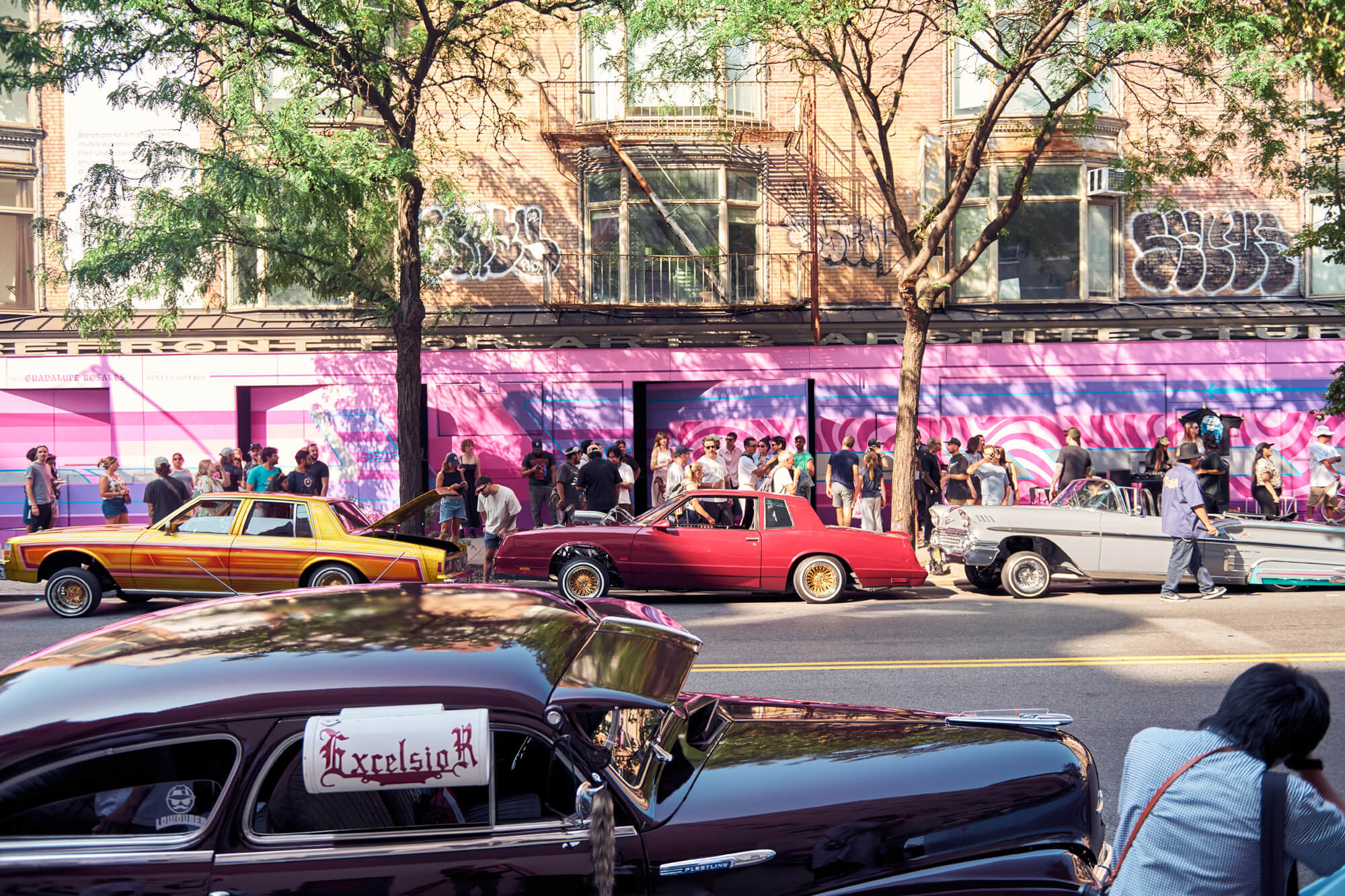 Cars out front of storefront for art and architecture