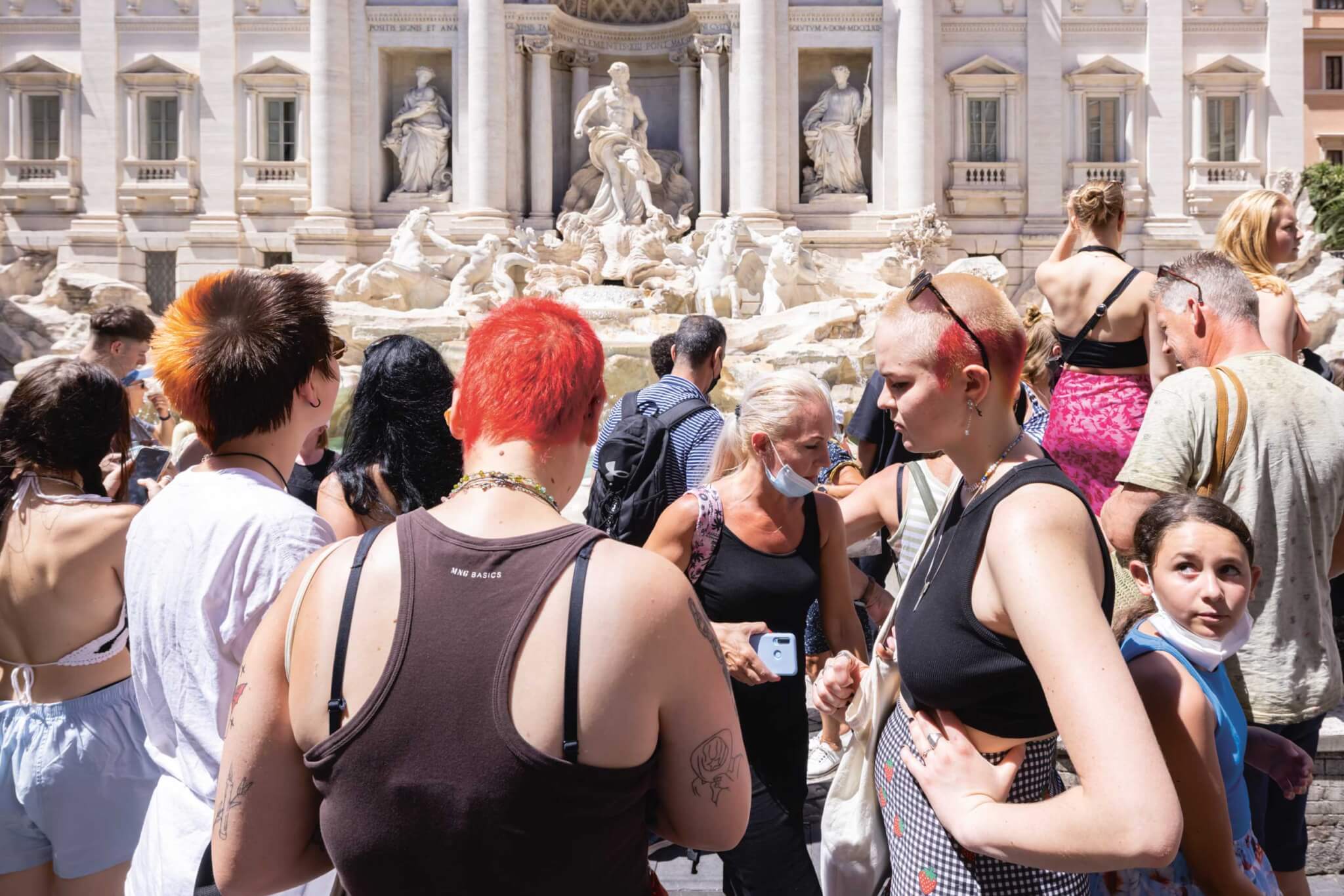 people crowding around Trevi Fountain in Rome