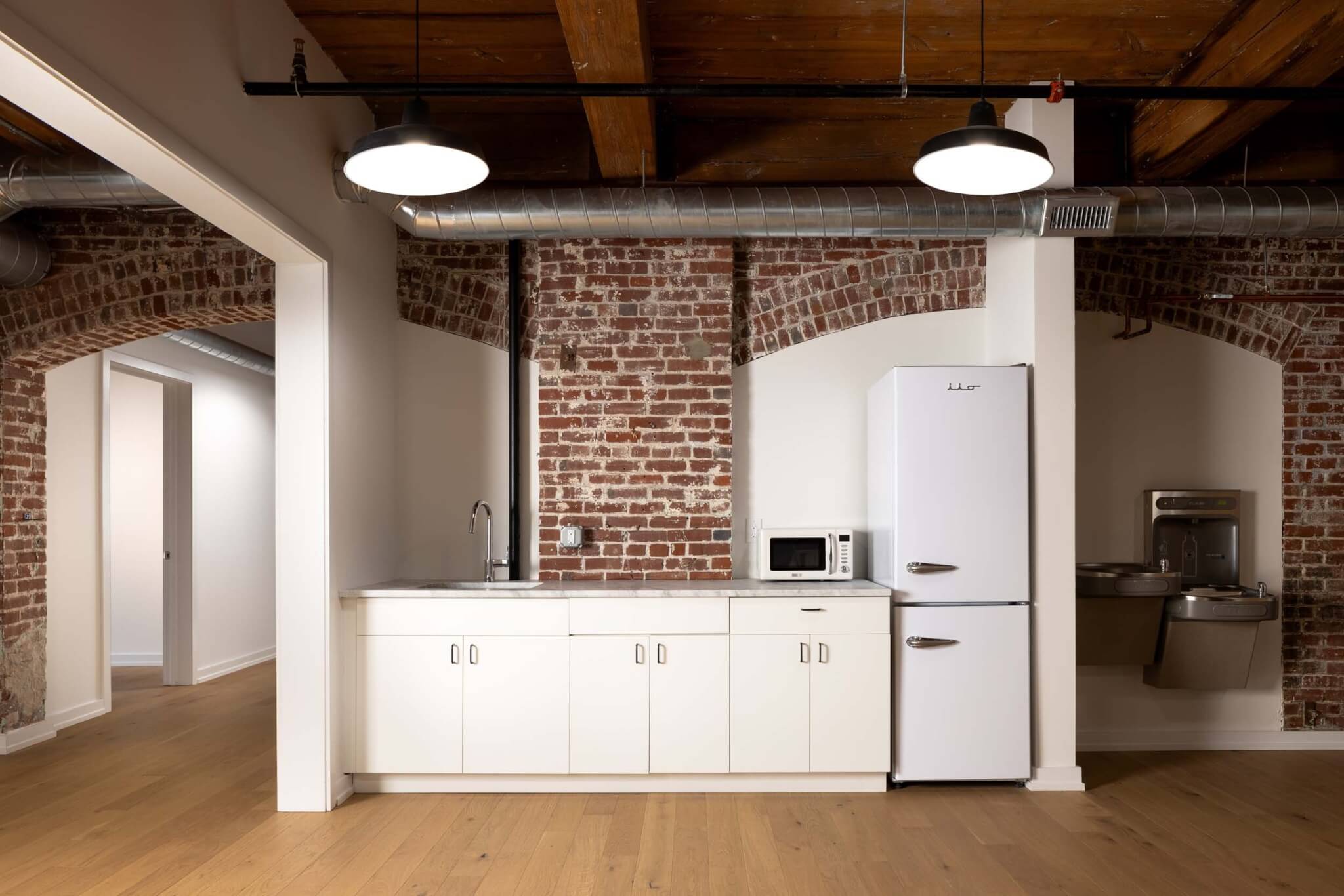 A kitchen area located on each floor in Silk Screen Studios by Kaminski+Pew