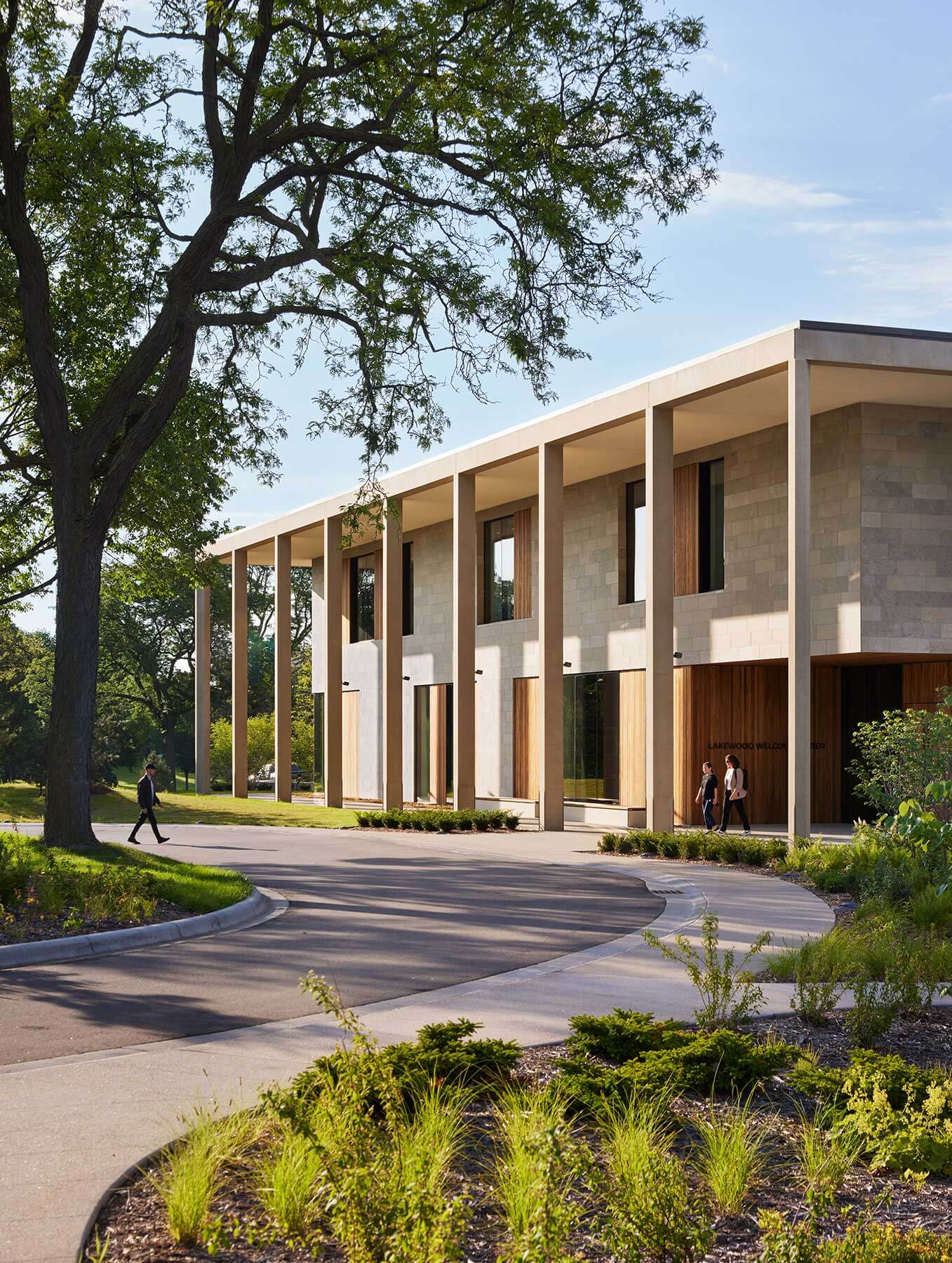 colonnade in building in landscape with trees and a pathway