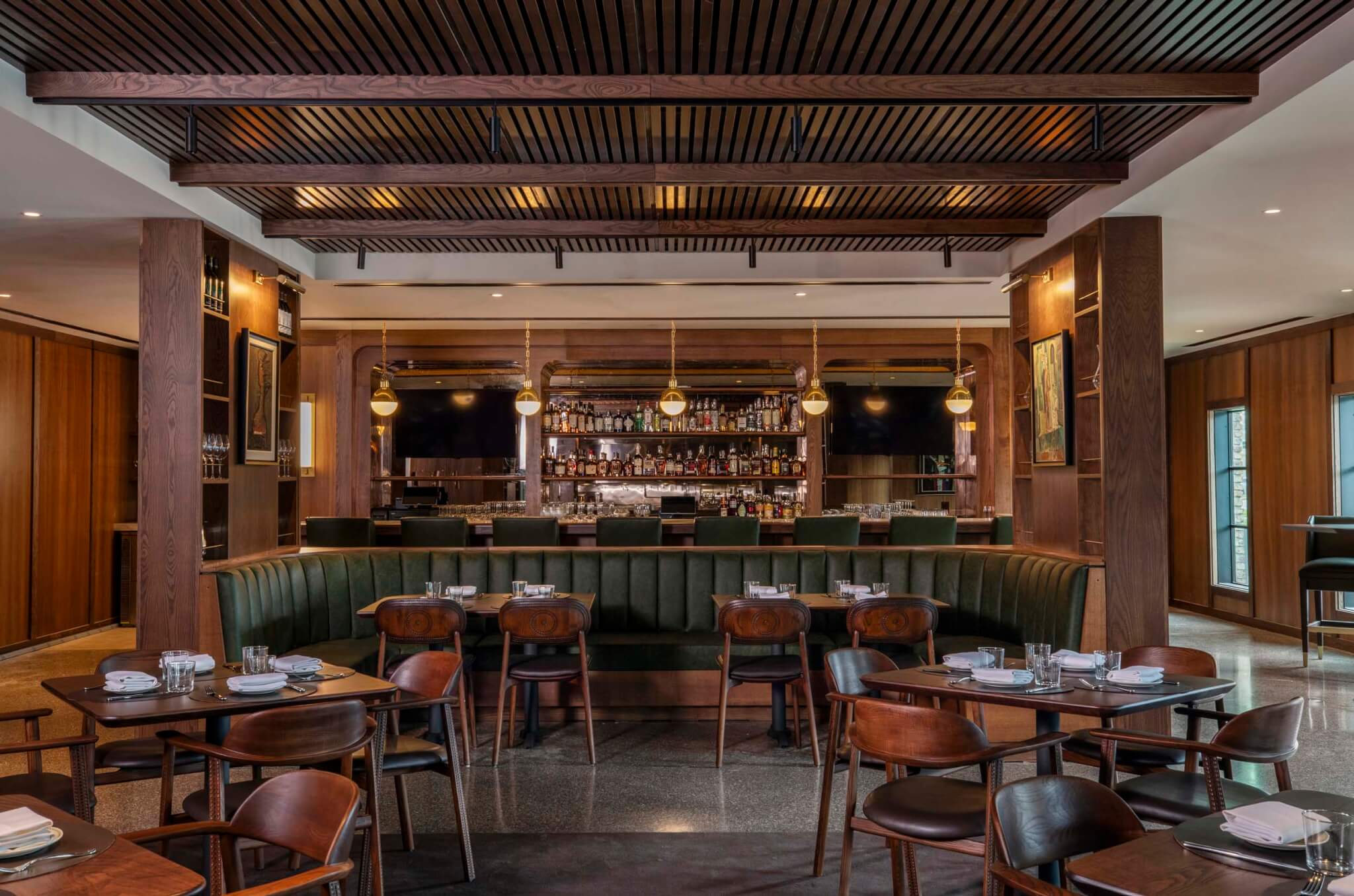 In Houston, Bar Bludorn features warm woods and green banquettes