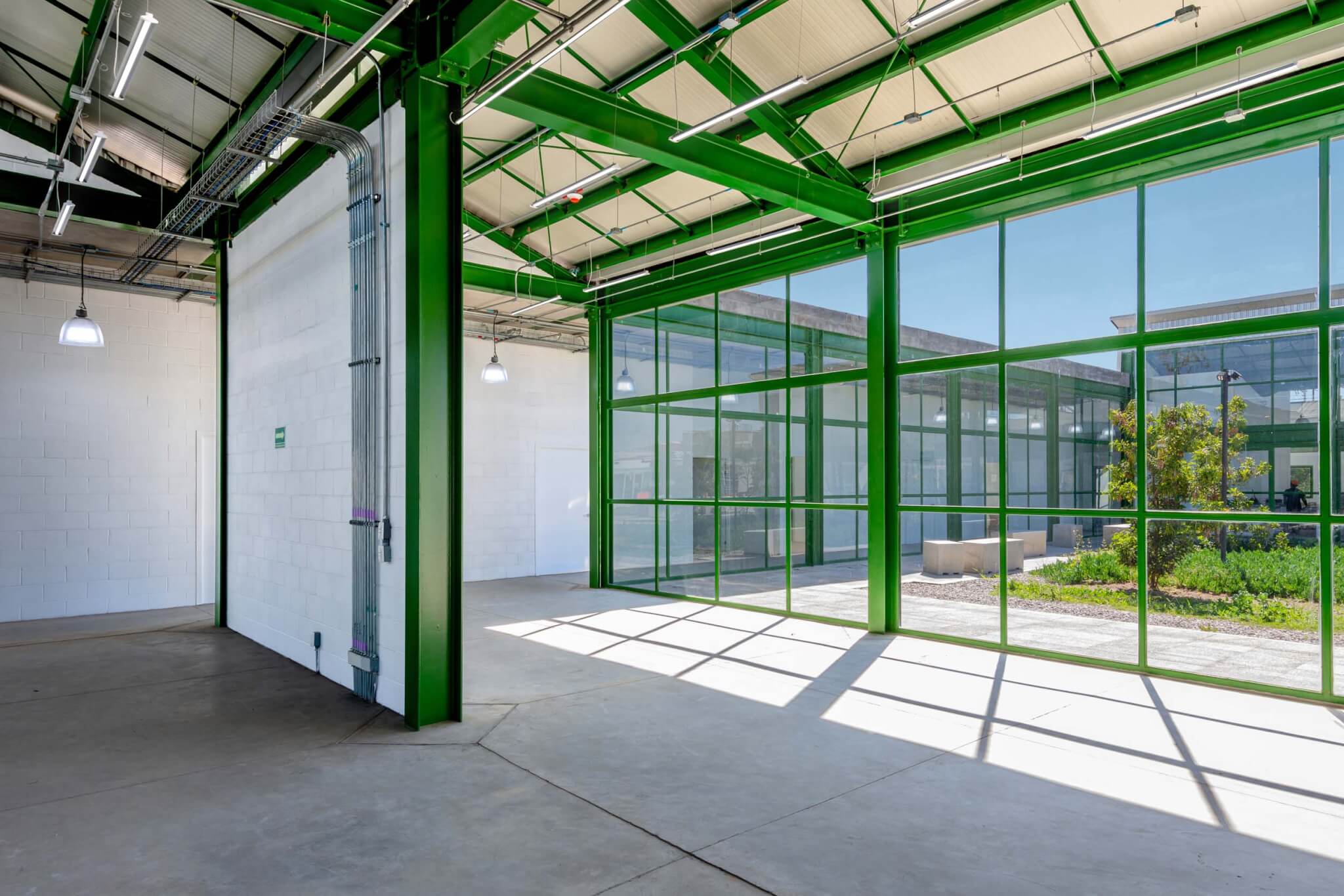 green columns and window mullions inside industrial building 