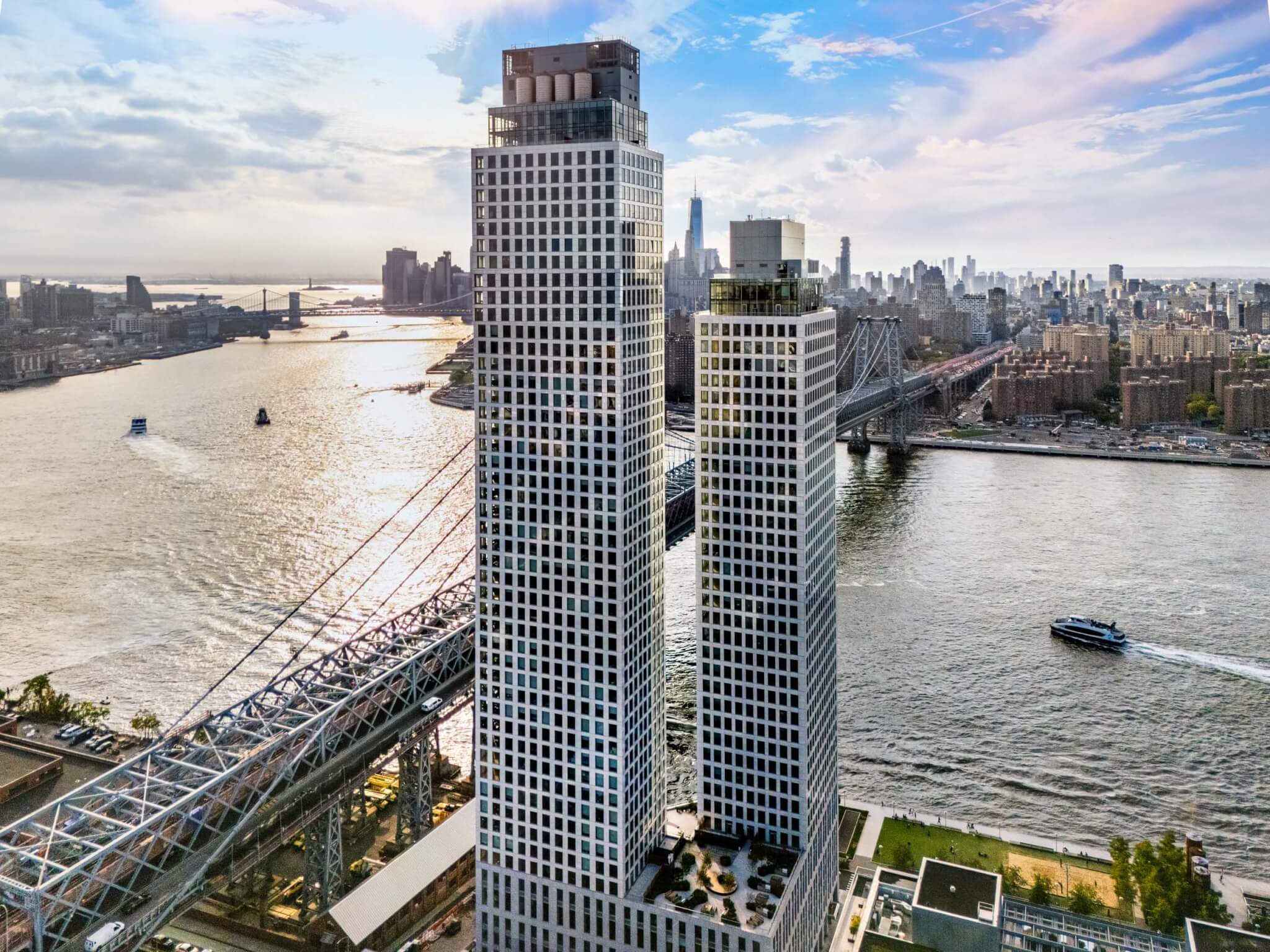 an aerial view of the two towers that comprise One Domino Square looking toward Manhattan skyline 