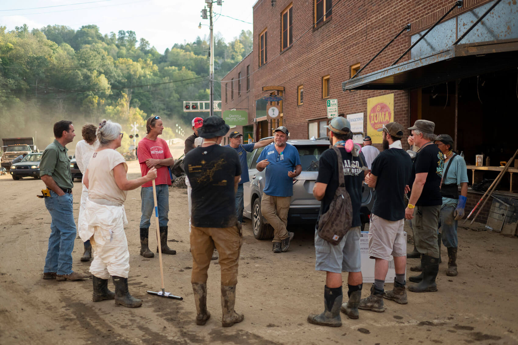 a group of people in Marshall, North Carolina discusses cleanup and reconstruction efforts