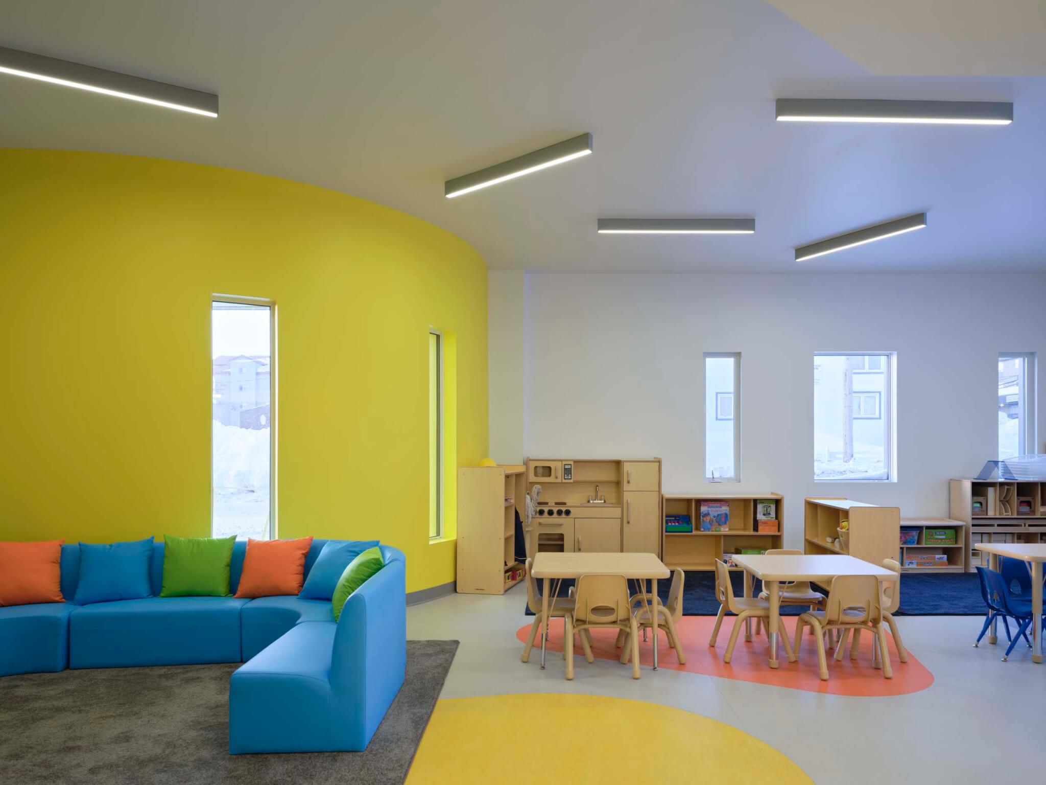 a yellow wall inside the day care space