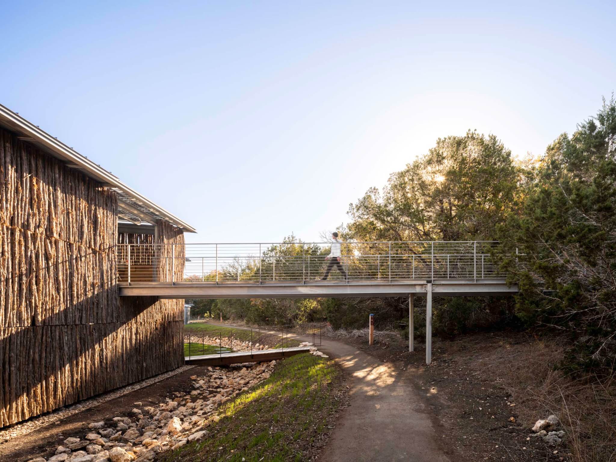 Andersson / Wise’s Shield Ranch was designed for a summer camp the building uses natural materials and is connected to nature via a metal crossing