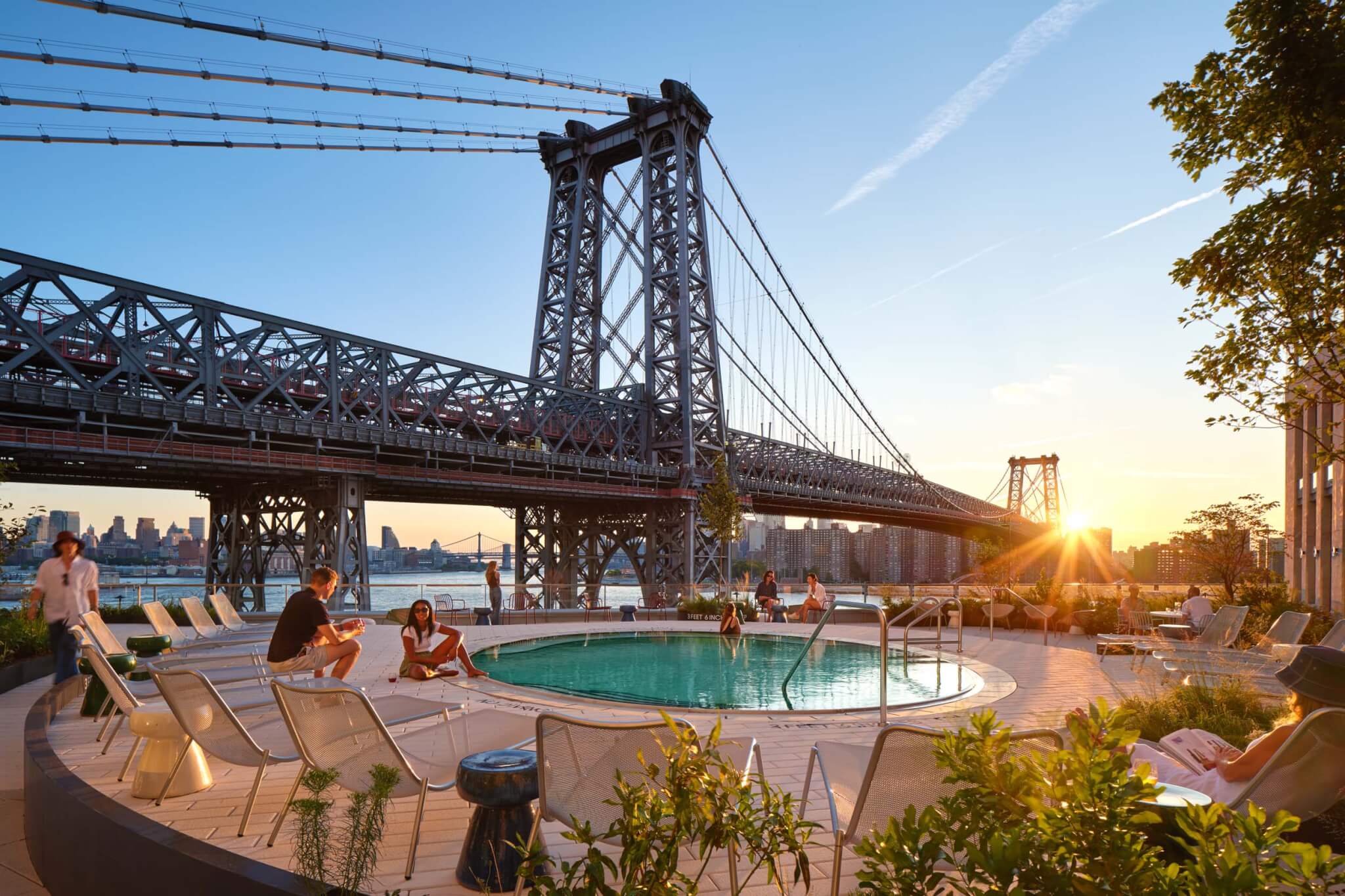 the outdoor pool at One Domino Square adjacent to the Williamsburg Bridge 