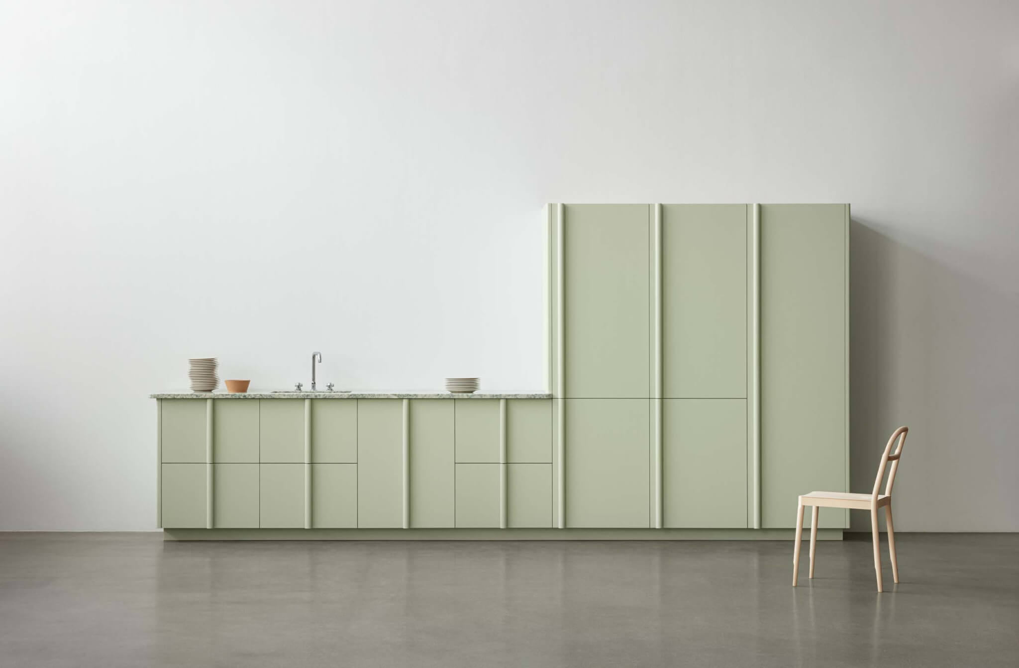 green cabinets against a white wall