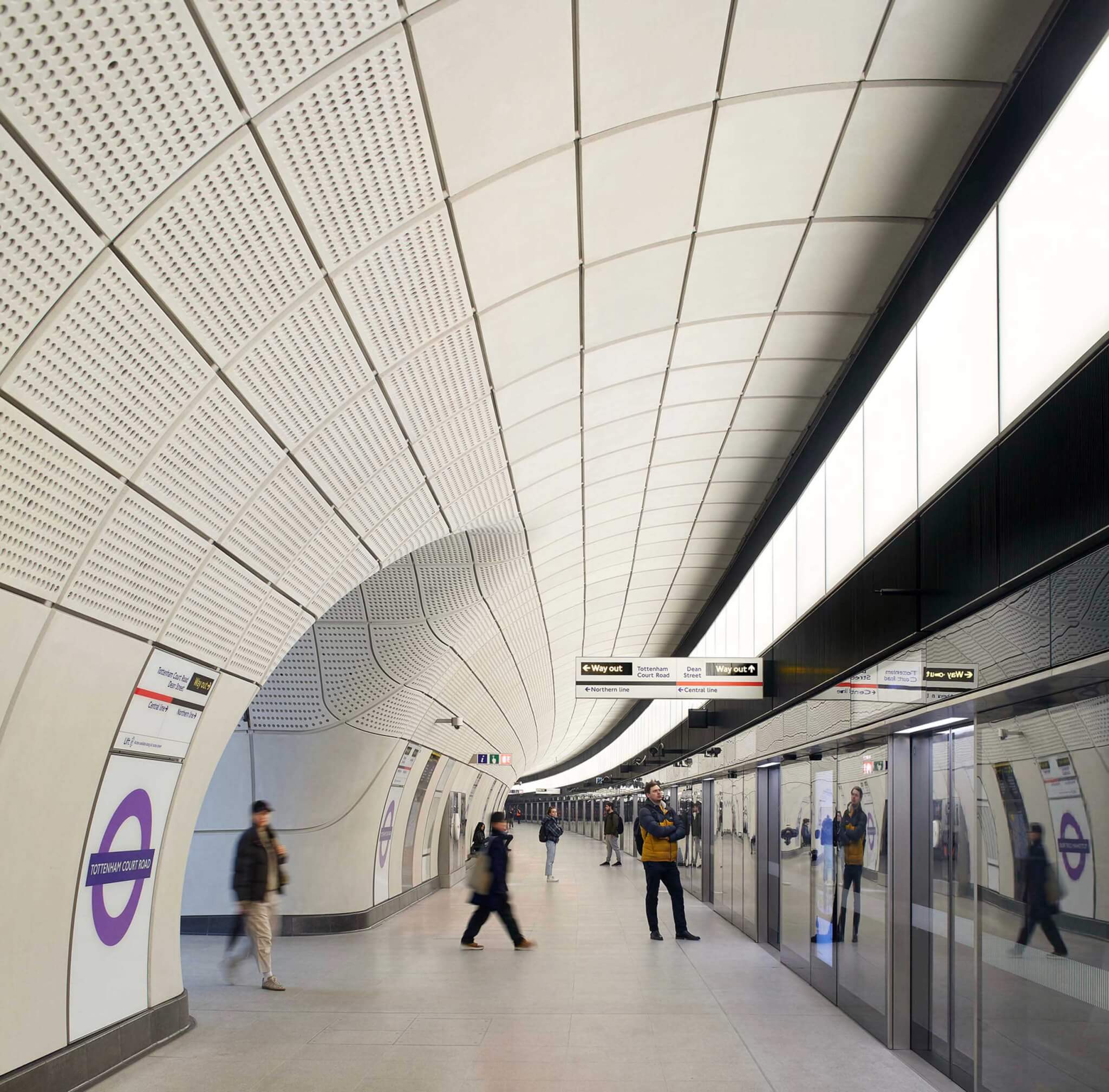 a white tunnel with signage for train lines in the Elizabeth Line network