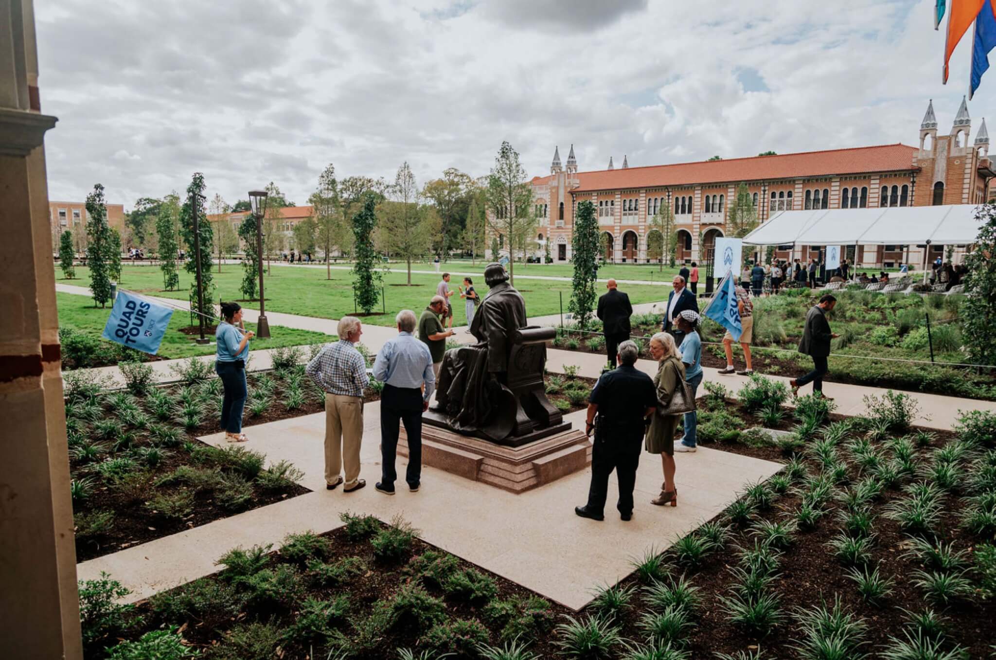 People gathered around the statue of the Rice founder